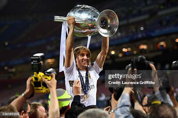 Luka Modric of Real Madrid celebrates with the trophy after victory in the UEFA Champions League Final match between Real Madrid and Club Atletico de...