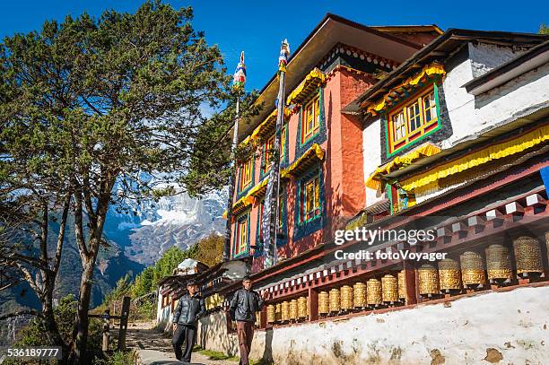sherpas by prayer wheels colorful monastery namche bazaar himalayas nepal - namche bazaar stock pictures, royalty-free photos & images