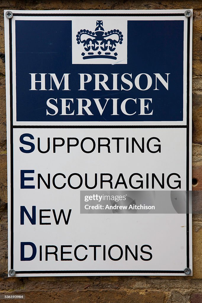 Prisoner Guide Sign A sign on the wall at the entrance to the prison. HM Prison Send is a ...