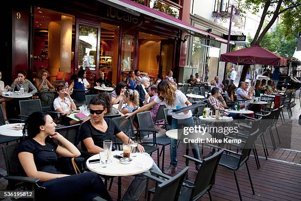 People out having afternoon coffee at cafes in Monastiraki. There is a very popular cafe scene in Athens with all sorts of people hanging out,...