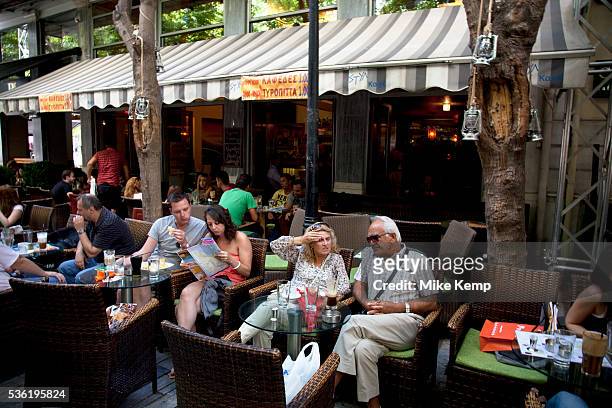 People out having afternoon coffee at cafes in Monastiraki. There is a very popular cafe scene in Athens with all sorts of people hanging out,...