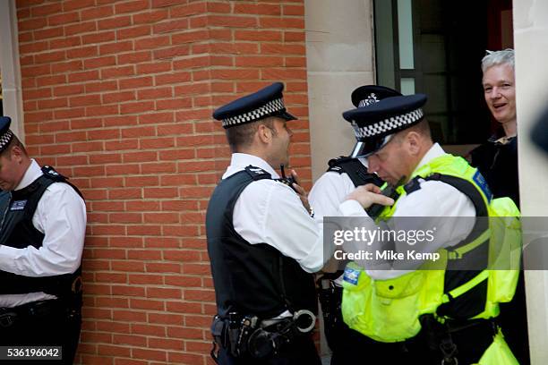 Julian Assange at the Occupy London demonstration 15th October 2011. Seen here after arriving in a taxi with his own security, he tries to get...