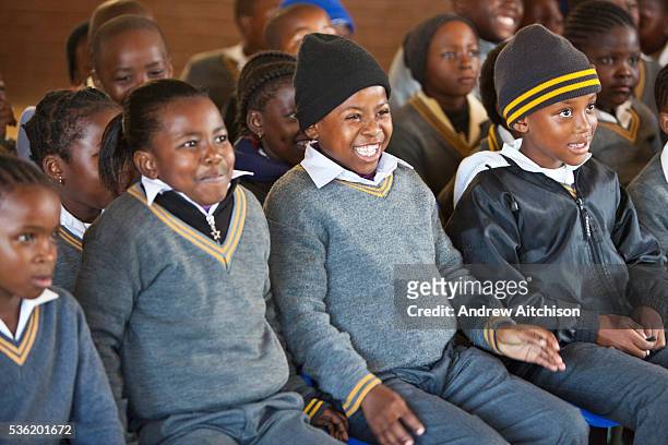 Children from Matsie Steyn primary school, Sharpeville, Vereeniging, South Africa, watch a performance of the ‘No Monkey Business' puppet show, an...
