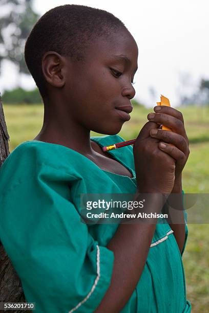 Girl at Nyamiyaga primary school plays a hearing test game run by Reverend Sam. Bwindi Community Hospital run health outreach programs covering 32...