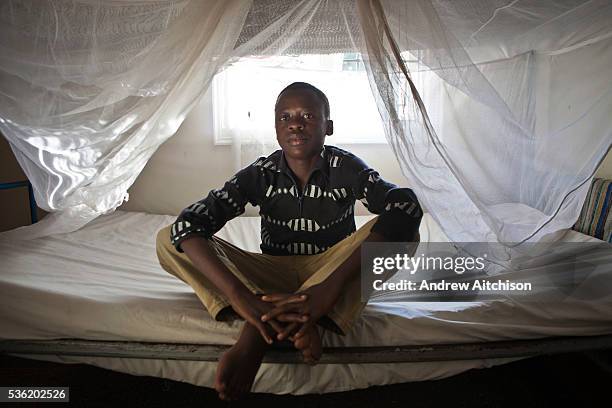 At the Wema Centre for boys in Mombassa, Kenya Gilbert sits on his bunk in the shared dormitory. Gilbert used to live at dumpsite collecting waste....