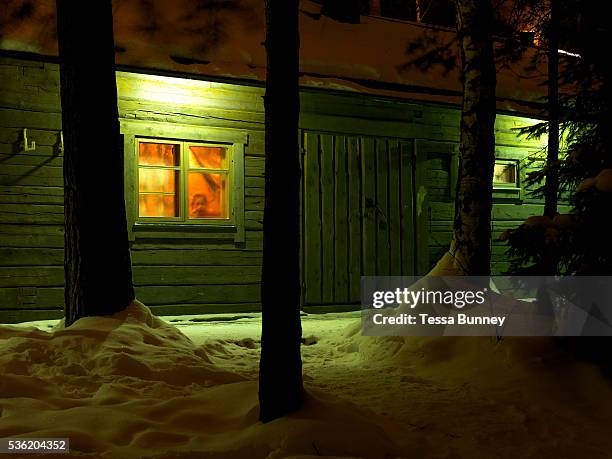 Young child looks out of the window of Jatkankamppa sauna in the grounds of the Spa Hotel Rauhalahti in Kuopio, Central Finland. It is the world's...