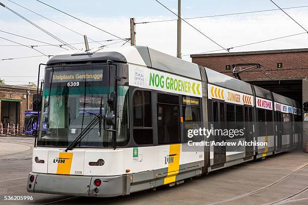 Modern De Lijn electric tram leaves the depot in Ghent, Belgium. The trams have been modernized to use less electricity and become more sustainable...