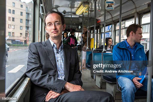 Portrait of Patrick De Boeuf, Chief Executive of De Lijn proudly sits on one of his modern electric tram buses on the Ghent Tramway Network in...