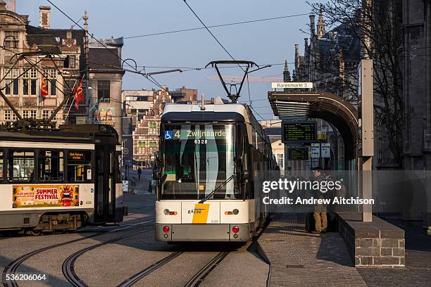 An electric tram at a station stop in the centre of Ghent city, Belgium. The Ghent tramway network is run by De Lijn.