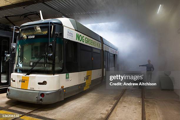 Patrick De Boeuf, Chief Executive of De Lijn, demonstrates the loss of heat from trams with a smoke machine in the tram depot in Ghent, Belgium. He...