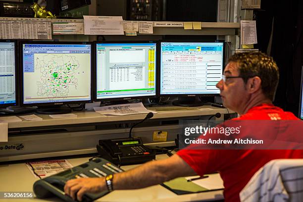 Male Belgian traffic controller monitors tram traffic flow on the Ghent tramway network in the De Lijn control centre, Ghent, Belgium.