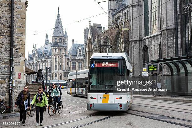 Passengers travel on a De Lijn electric tram on route 1 to Evergem on the Ghent tramway network in Ghent, Belgium. The trams have been modernized to...