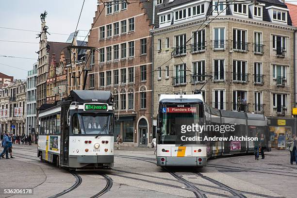 Two De Lijn trams travel along the Ghent tramway network in central Ghent, Belgium. The tram on the left is route 4 to Zwi jnaarde, the tram on the...