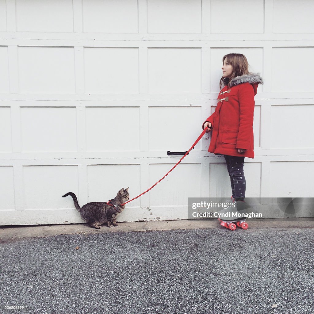 Girl on Roller Skates Walking Cat
