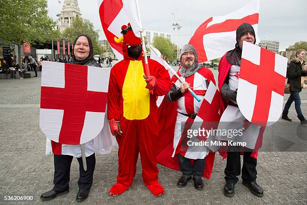 London, UK. Wednesday 23rd April 2014. Men dressed up as Saint George and one dragon on St George's Day. With chainmail, St Georges Cross shields and...