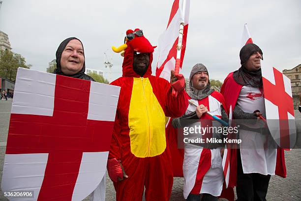 London, UK. Wednesday 23rd April 2014. Men dressed up as Saint George and one dragon on St George's Day. With chainmail, St Georges Cross shields and...
