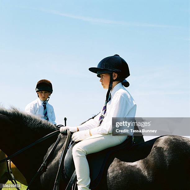 Farmer's children, Giles and Hannah Hawkins sitting on their horses at Pony Club, Exmoor, Somerset, UK