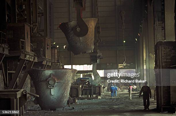 In the heat and dust of a post-communist industrial mill, we see Bulgarian copper manufacturing workers made small against the scale of a bucket...