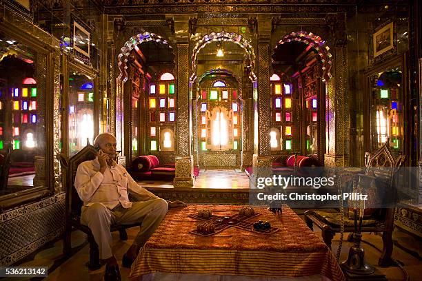 Nobleman Nahar Singhji, also known as Rao Saheb, sits in the Sheesh Mahal suite of Deogarh Mahal a 340 year old architectural jewel, now converted...