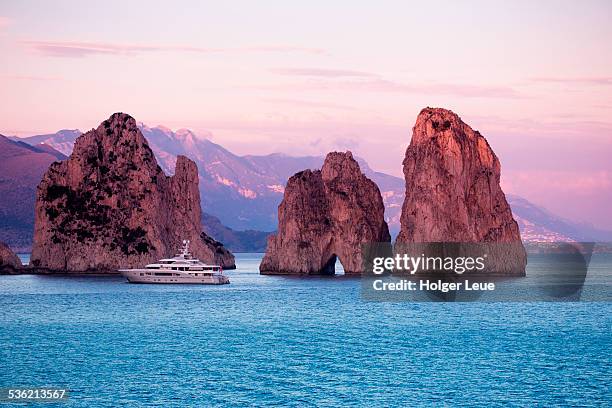 luxury yacht near faraglioni rocks at sunset - isle of capri sunset stock pictures, royalty-free photos & images