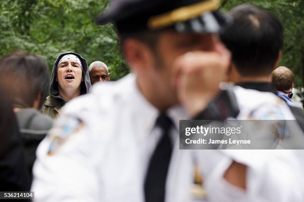 White" shirted police officer surveys the scene at the protest "Occupy Wall Street" in its third week at Zuccotti Park near Wall Street in Manhattan.