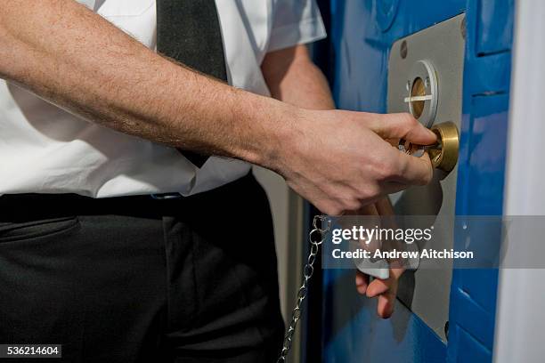 Prison officer unlocks a cell door during a training exercise. HMP Wandsworth, London, United Kingdom.