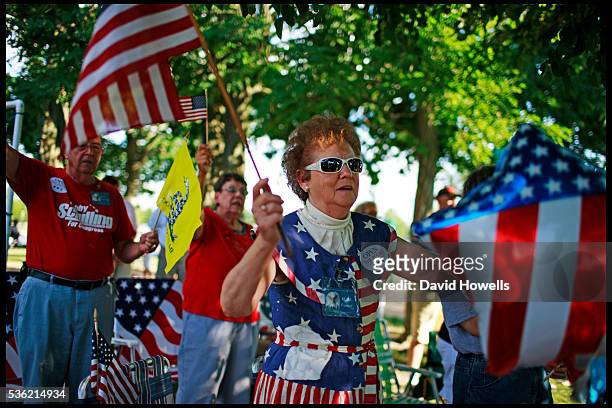 Hazell Fennel holds a stars and stripes at a Tea Party meeting in Forsyth, Illinois. July 2010. | Location: Forsyth, Illinois, USA.