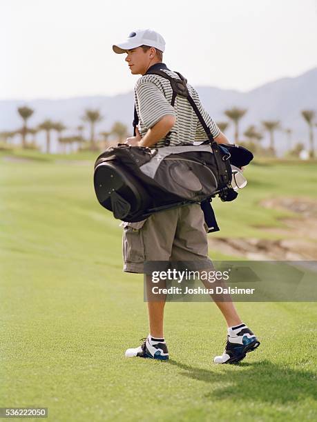 man carrying golf bag - joshua dalsimer stock pictures, royalty-free photos & images