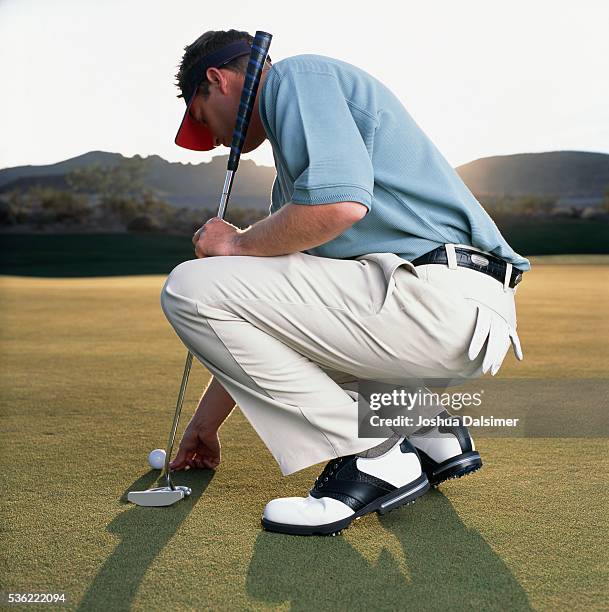 golfer applying ball marker - joshua dalsimer stock pictures, royalty-free photos & images