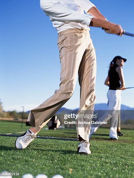 golfers teeing off - golf shoe stock pictures, royalty-free photos & images