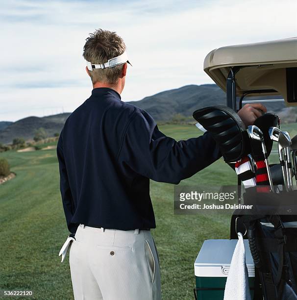 golfer selecting golf club - joshua dalsimer stock pictures, royalty-free photos & images