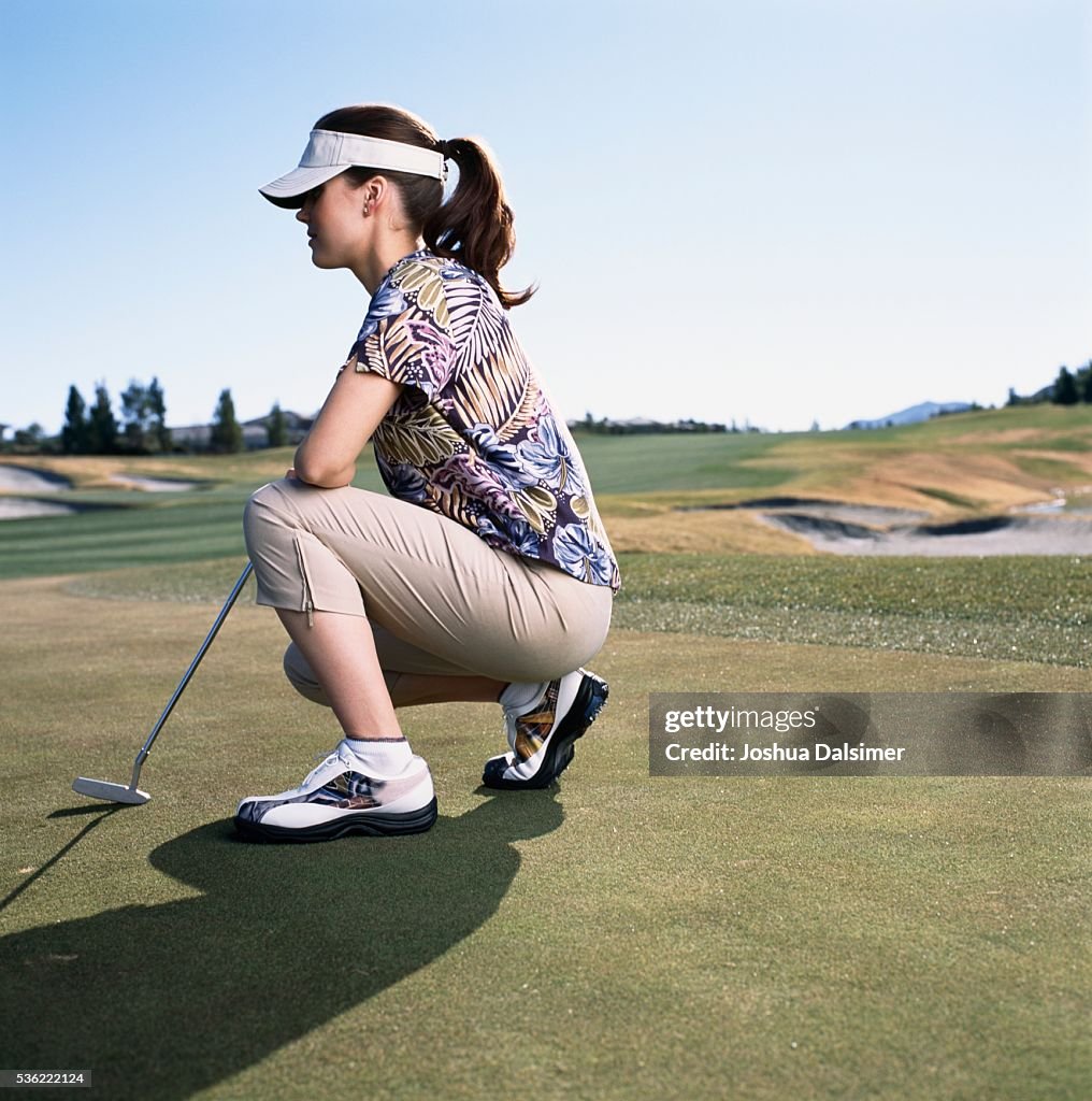 Golfer crouching