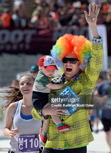 Matt Barber of Denver and son Bridger make their way to the finish line. The 38th BolderBOULDER takes place along Boulder's streets with the finish...