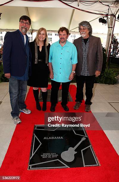 Teddy Gentry, Jeff Cook and Randy Owen from Alabama poses for photos with Nashville's Mayor Megan Barry after receiving a star on the Music City Walk...