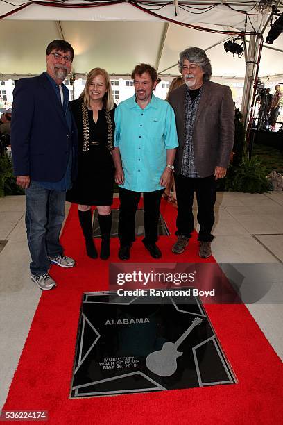 Teddy Gentry, Jeff Cook and Randy Owen from Alabama poses for photos with Nashville's Mayor Megan Barry after receiving a star on the Music City Walk...