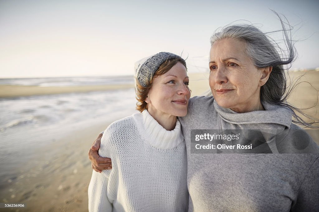 Mother and adult daughter on beach