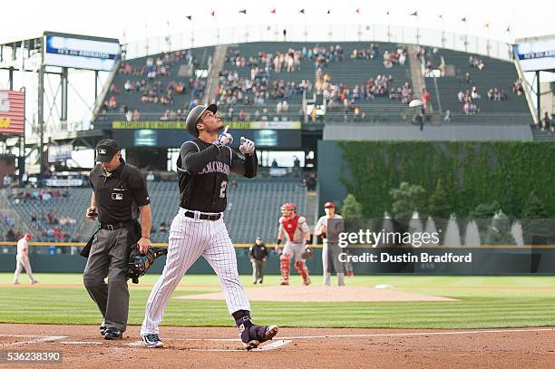 Nolan Arenado of the Colorado Rockies celebrates after hitting a first inning two-run home run off of Jon Moscot of the Cincinnati Reds at Coors...