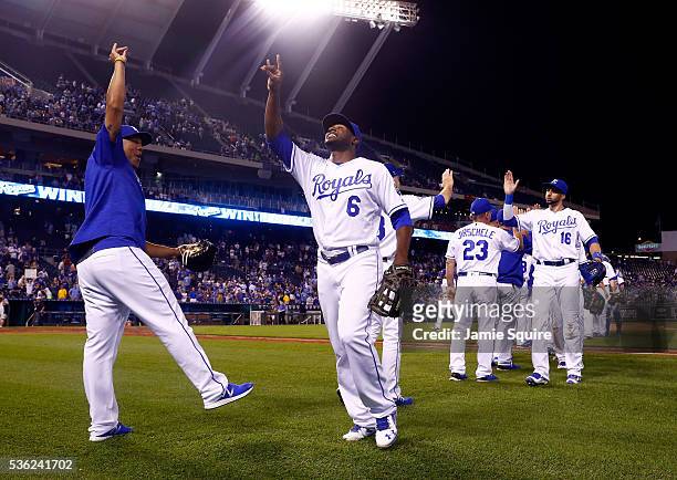 Lorenzo Cain and Salvador Perez of the Kansas City Royals celebrate after the Royals defeated the Tampa Bay Rays 10-5 to win the game at Kauffman...