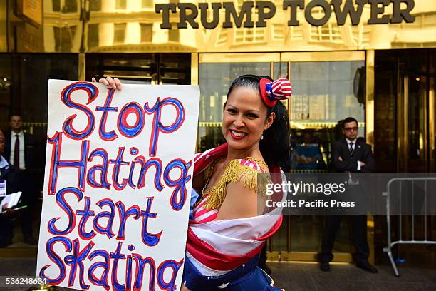 Activist Marni Halassa in front of Trump Tower with anti-hate sign. Pro and anti Trump activists gathered outside Trump Towers during candidate's...