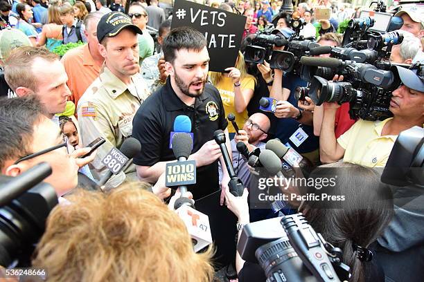 Former Marine Alexander McCoy talks to press outside Trump Tower during Vets vs Hate rally. Pro and anti Trump activists gathered outside Trump...