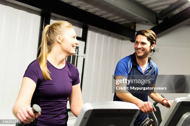 enjoying the gym - happy caucasian woman on elliptical trainer at gym stock pictures, royalty-free photos & images