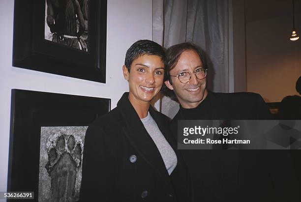 American fashion photographer Herb Ritts and Ingrid Casares at the 'Africa' exhibition opening, Staley-Wise Gallery, New York City, USA,1994.
