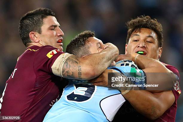 Greg Bird of the Blues is tackled during game one of the State Of Origin series between the New South Wales Blues and the Queensland Maroons at ANZ...