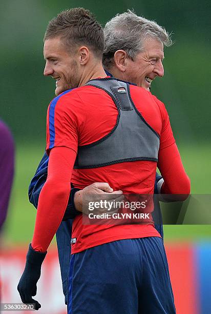 England's manager Roy Hodgson reacts as he embraces England's striker Jamie Vardy during a team training session in Watford, north of London, on June...