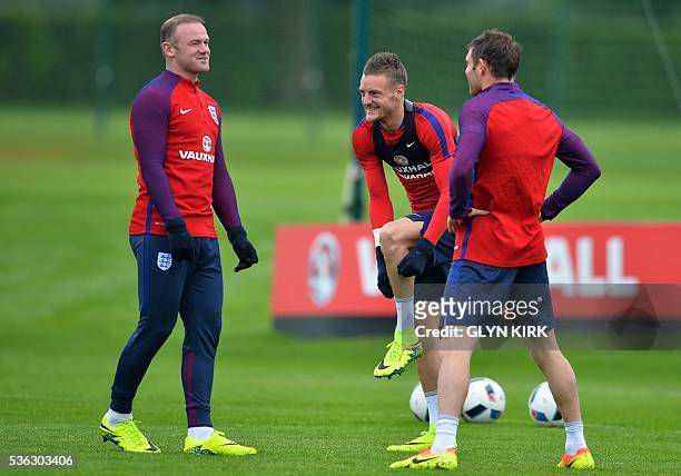 England's striker Wayne Rooney , England's striker Jamie Vardy and England's midfielder James Milner react as they warm up during a team training...