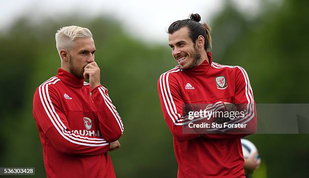 Aaron Ramsey and Gareth Bale share a joke during Wales training at the Vale hotel complex on June 1, 2016 in Cardiff, Wales.