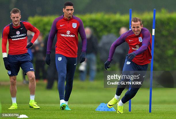 England's striker Jamie Vardy , England's defender Chris Smalling and England's striker Harry Kane take part in a team training session in Watford,...