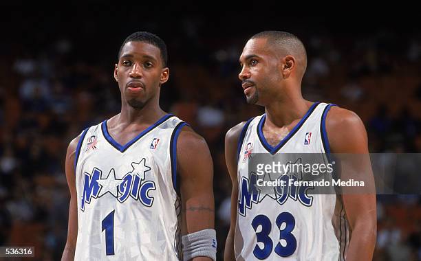 Forwards Tracy McGrady and Grant Hill of the Orlando Magic confer during the NBA game against the Toronto Raptors at TD Waterhouse Centre in Orlando,...
