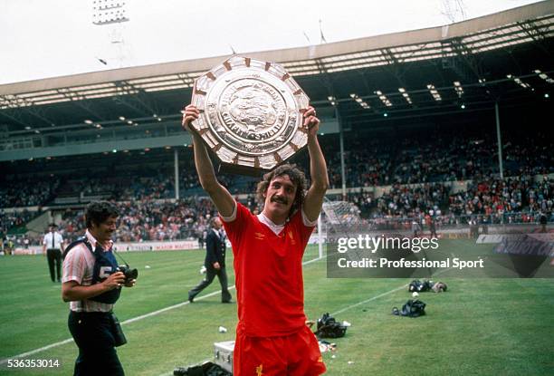 Terry McDermott of Liverpool carrying the FA Charity Shield following their victory over West Ham United at Wembley Stadium in London, 9th August...