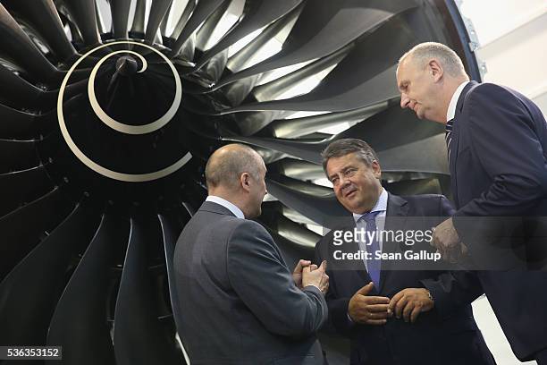German Vice Chancellor and Economy and Energy Minister Sigmar Gabriel and Brandenburg Governor Dietmar Woidke stand under a jet turbine while...